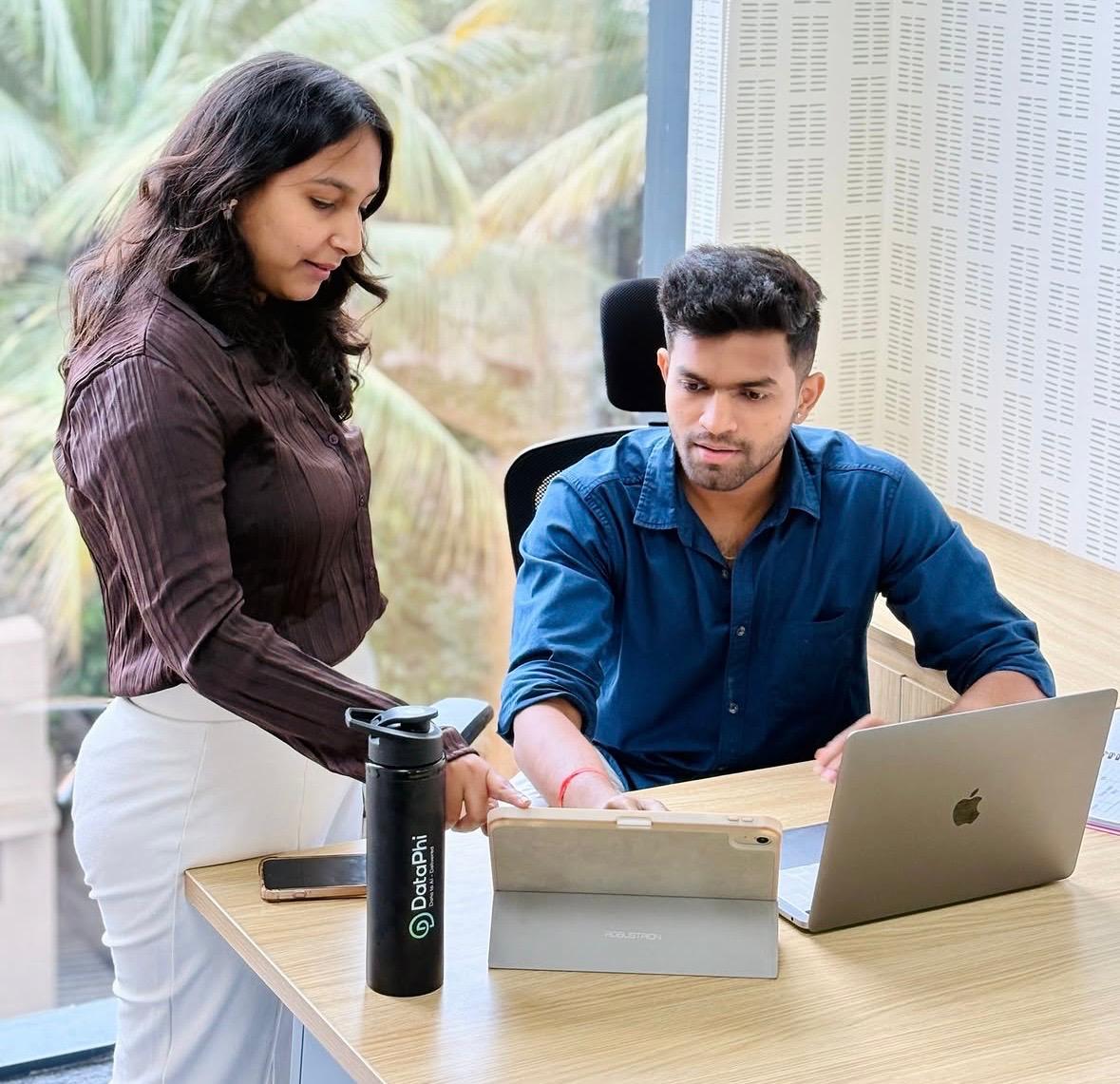 Colleagues collaborating seamlessly at a workstation